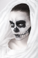 Portrait of young woman with skull make-up.