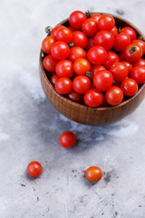 small tomatoes in a wooden bowl
