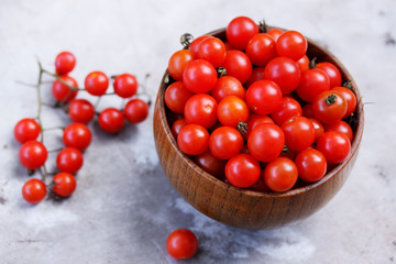 Fototapeta na wymiar tomatoes in a wooden bowl, top view