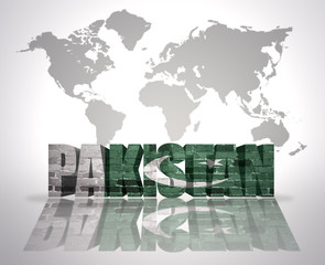 Word Pakistan on a world map background
