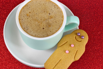 Christmas Coffee and gingerbread man on red glitter background