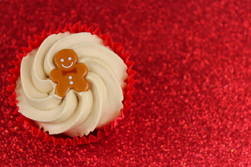 Christmas Cupcake on Red Glitter Background.