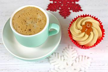 Holiday Coffee and cupcake on a rustic white wood background.