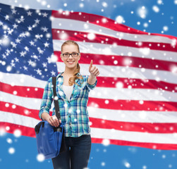 smiling girl in casual clothes showing thumbs up