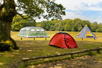 Three big colorful tents in woodlands campground