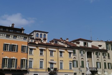 Fototapeta na wymiar Colorful houses at a square in Brescia in Lombardy in Italy
