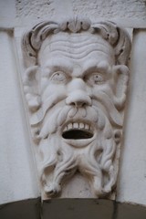 A face of a man as decoration on the loggia in Brescia