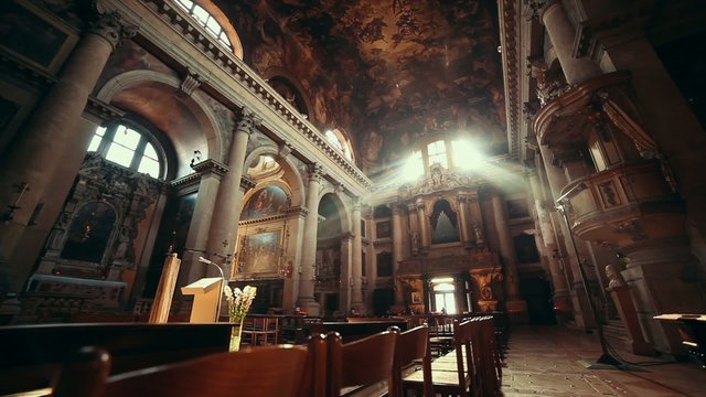 Sun Rays Beaming Through The Old Glass Window of Church
