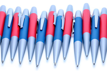 Silver-blue and silver-red metal pens on white background