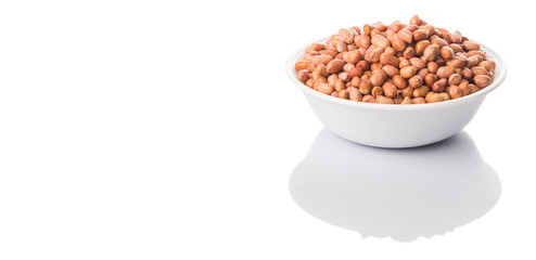 Peanut or ground nut in white bowl over white background