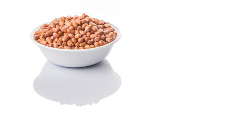 Peanut or ground nut in white bowl over white background