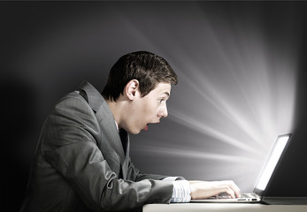 Emotional man using laptop