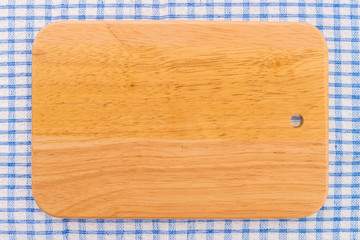 wood cutting board on tablecloth