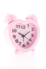 Pink alarm clock isolated on white background