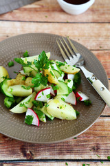 Boiled potatoes with radish and greens