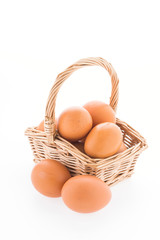 Eggs in basket isolated on white background