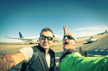 Hipster young friends taking a selfie at international airport