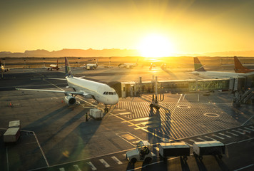 Fototapeta premium Airplane at the terminal gate in international airport