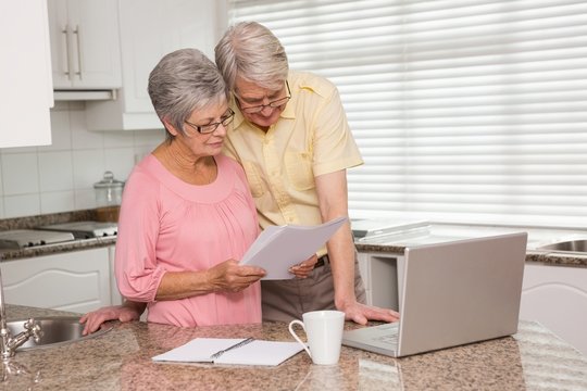 Senior Couple Paying Their Bills With Laptop