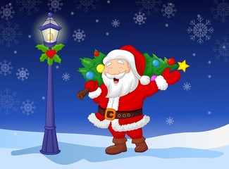 Santa carrying a Christmas tree