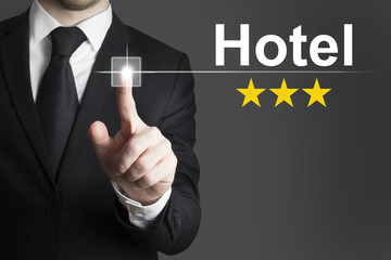 businessman pushing button hotel three stars