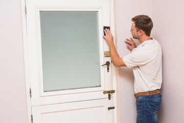 Fototapeta premium Man hand sanding the door before refinishing