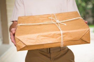 Close up of delivery man giving package