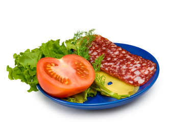 sausage, tomato and cheese on a plate