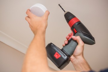 Handyman installing smoke detector