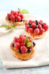 Sweet cakes with berries on table close-up