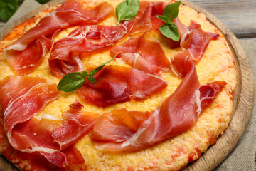 Delicious pizza served on wooden table