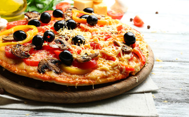 Delicious pizza served on wooden table