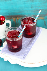 Closeup of cherry granita in glasses, on color wooden