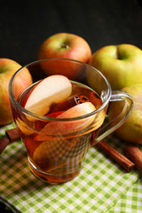 Apple cider with cinnamon sticks and fresh apples
