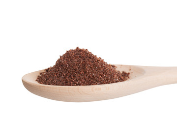 Sumac spice in a wooden spoon, is isolated on a white background