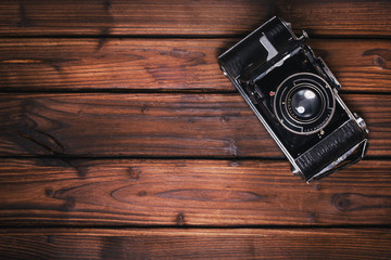 Vintage camera on wooden background