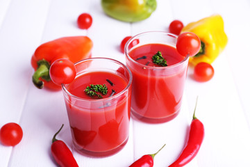 Tomato juice in glasses and fresh vegetables