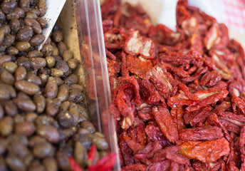 olives and dried tomatoes on sale in the market of Italy