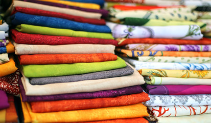 lots of colored cloth tablecloths for sale in the town market