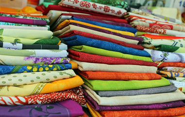 lots of colored cloth tablecloths for sale in the city market
