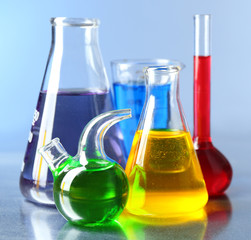 Different laboratory glassware with colorful liquid