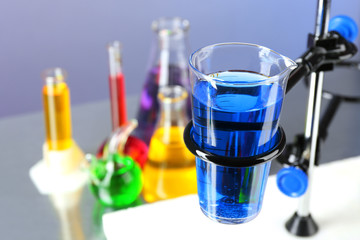 Different laboratory glassware with colorful liquid