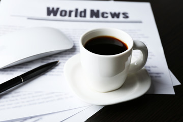 On-line news concept. Computer mouse, cup of coffee and