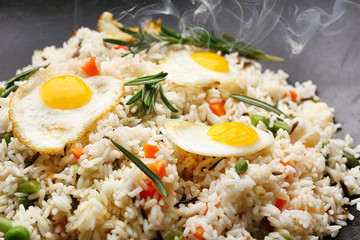 Tasty rice preparing in wok, close-up