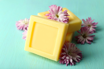 Obraz na płótnie Canvas Bars of natural soap and fresh flowers