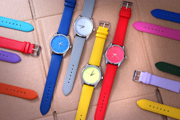 set of colorful watches on cardboard background - 73826903
