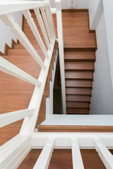 wooden staircase made from laminate wood in white modern house