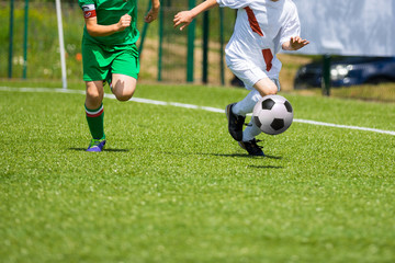 Football match for children. Boys playing football