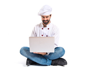 Chef with laptop over isolated white background