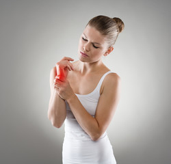Woman touching her injured wrist in pain. Hand sprain concept